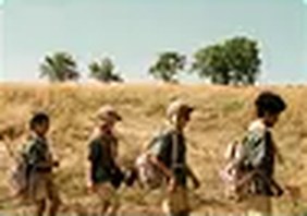 Group of hunters walking through a field