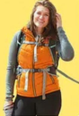 Hiker wearing an orange puffer vest
